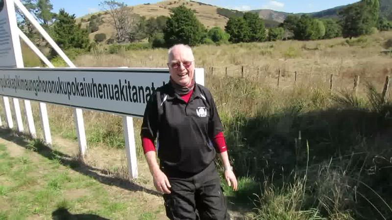 The end of the sign and the man beside it