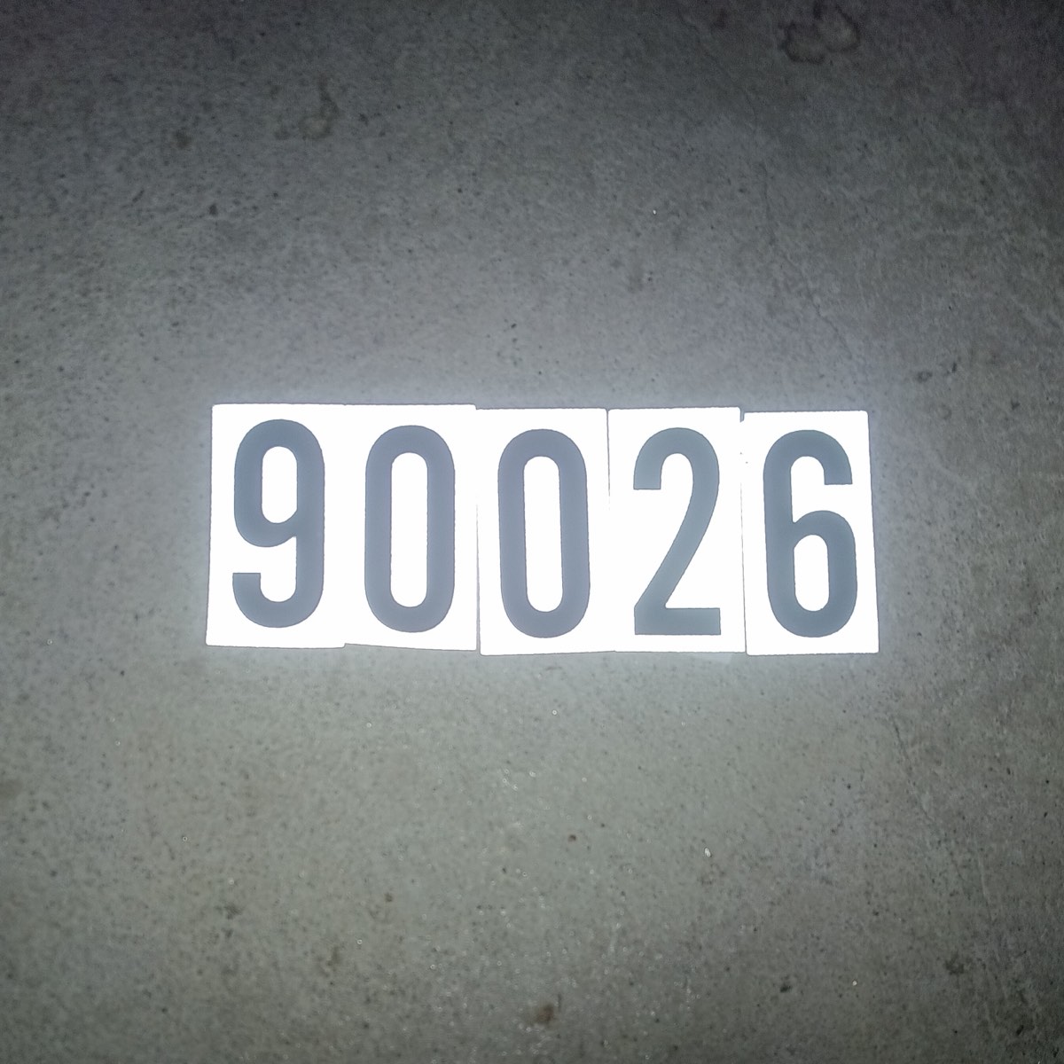 Stick-on vinyl numbers reading 90026 on a wall