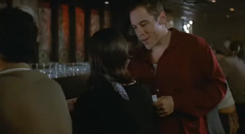 Swingers: a guy in a red shirt chatting up a woman at a crowded bar